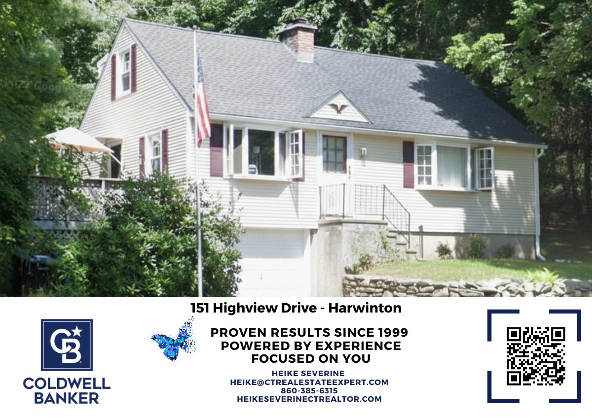 Front exterior of 151 High View Drive in Harwinton, CT featuring a Cape Cod-style home with attached garage, stone retaining wall, and wooded backdrop.